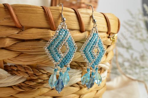 Handmade bead woven dangle earrings in the shape of rhombus of light blue color - MADEheart.com